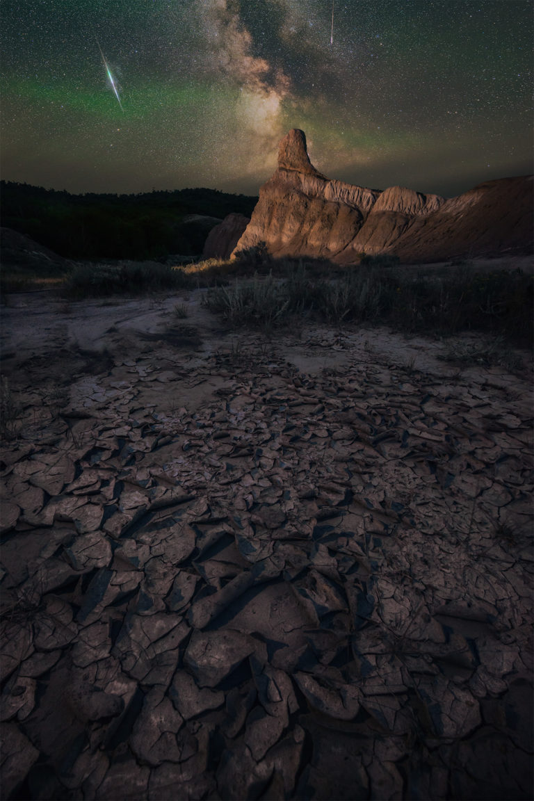 The perseids meteor shower and milky way over a hoodoo in Saskatchewan