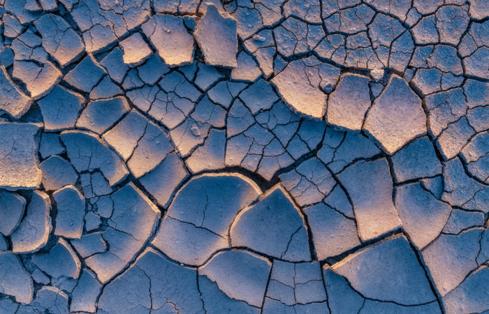 an intimate landscape photograph of clay textures and light