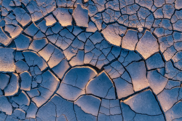 an intimate landscape photograph of clay textures and light