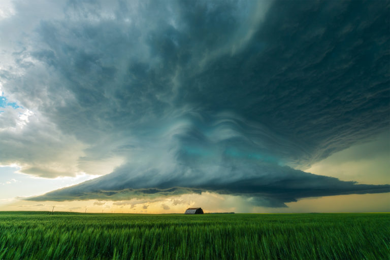 A supercell thunderstorm over a barn on the canadian prairies