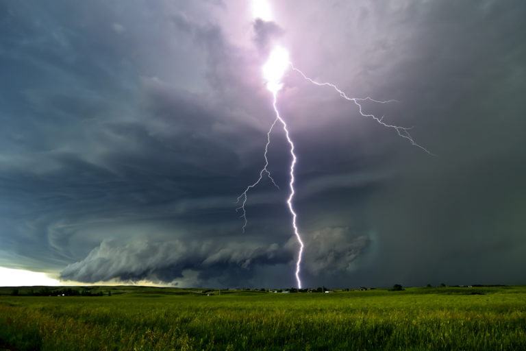 A lightning bolt through a supercell thunderstorm during a storm chase