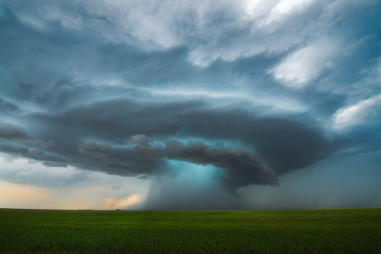 A supercell thunderstorm with tornado touching down in saskatchewan